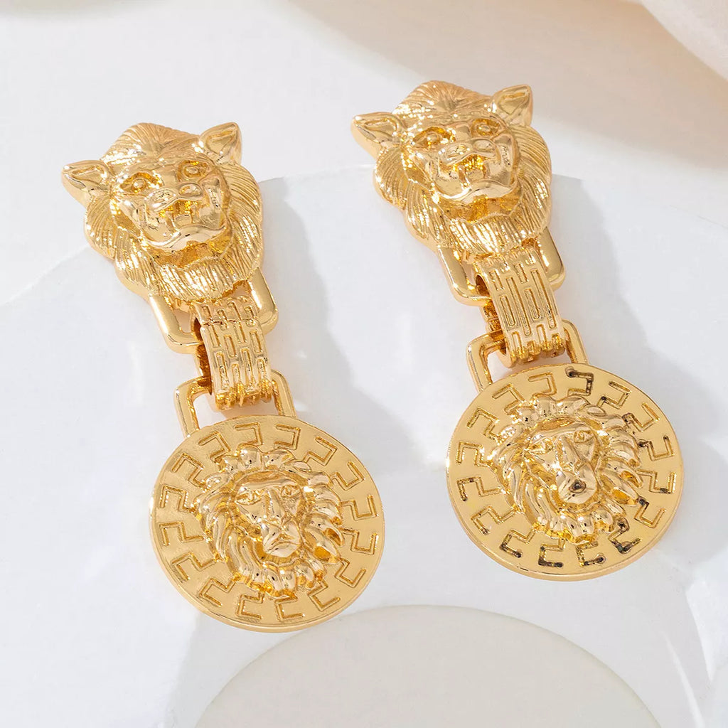 18K gold-plated lion head medallion drop earrings with detailed lion face design, hanging from elegant hooks.
