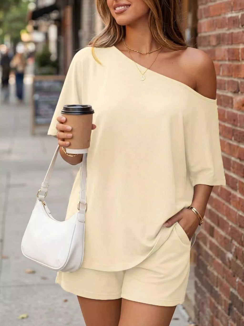 Full size one-shoulder top and shorts set by Plush Fashion Hub, featuring a stylish plus-size casual outfit with a modern design.