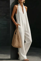 Women's sleeveless wide-leg jumpsuit with pockets, casual chic romper by Trendsi, shown in a relaxed fit with stylish design.