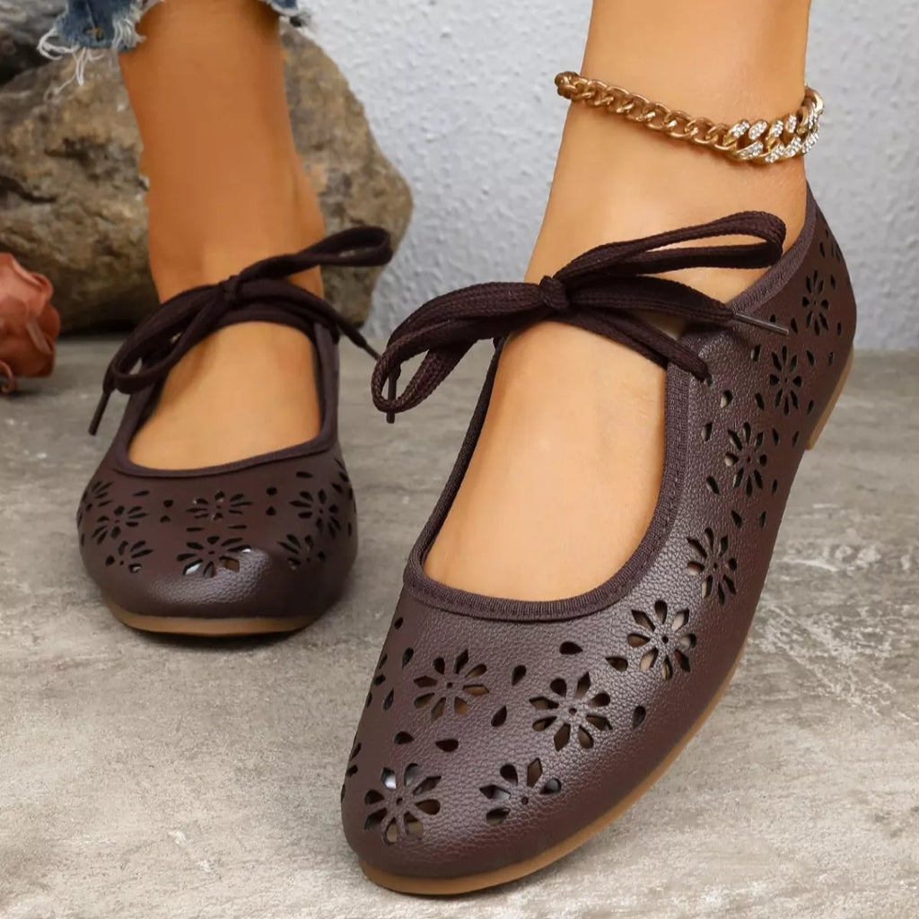 Floral cutout tied slip-on sandals by Plush Fashion Hub with open toes and stylish floral design, perfect for casual summer wear.