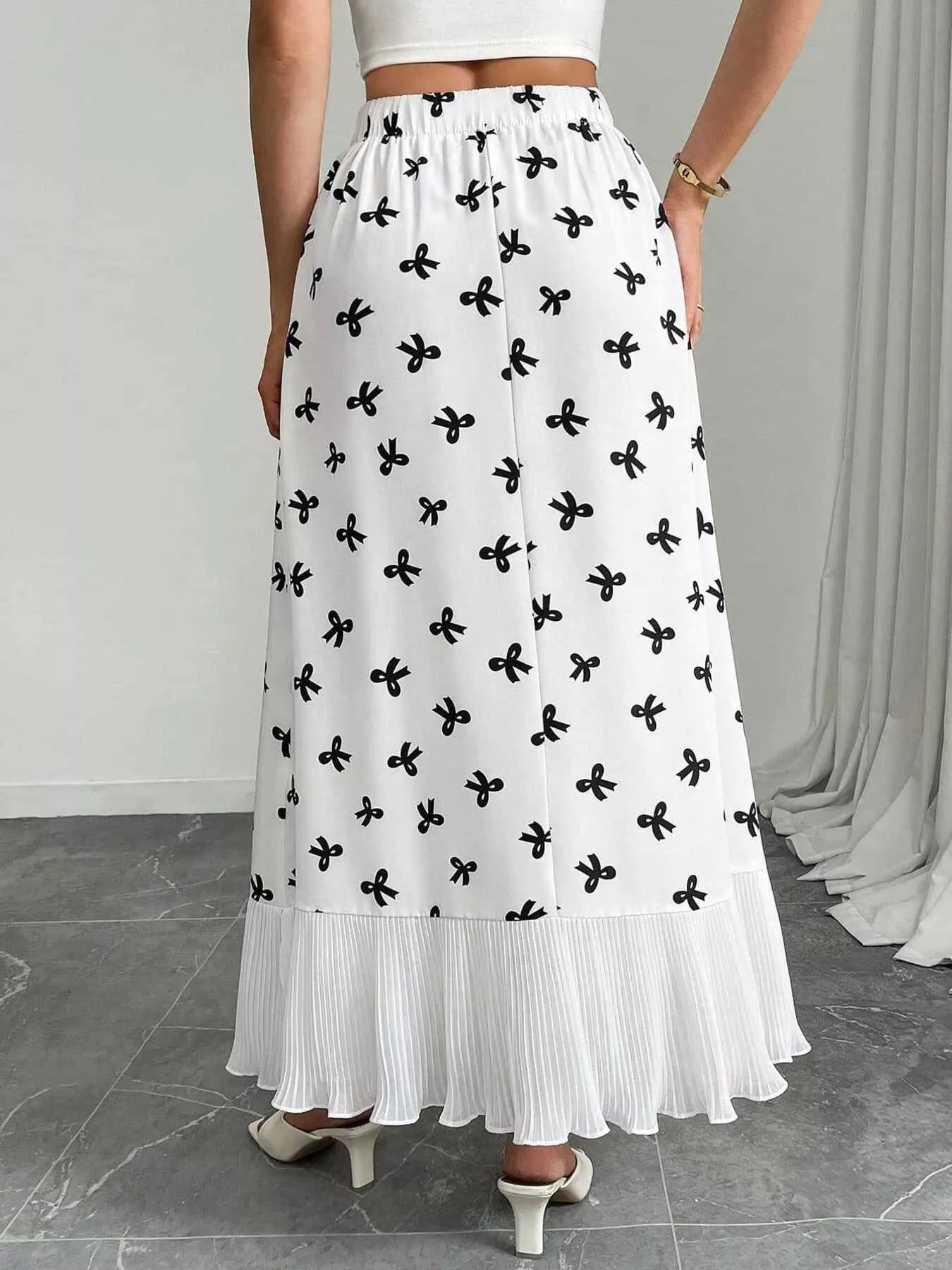 Flowy maxi skirt with bow print and ruffle hem from Trendsi, featuring lightweight fabric and a relaxed, feminine silhouette.