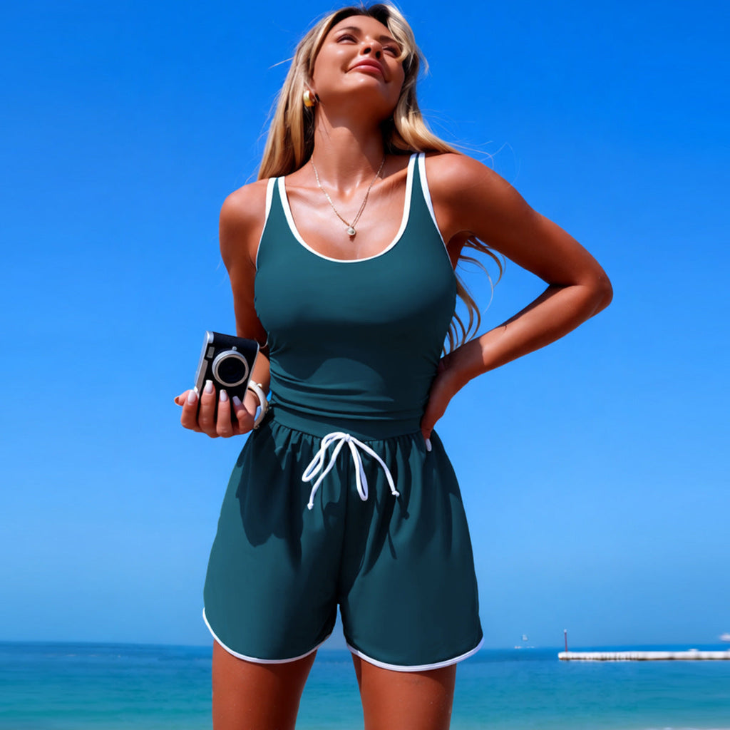 Women's minimalist FitiqueFit sleeveless one-piece swimsuit in solid color, designed for sporty and sleek swimwear style.