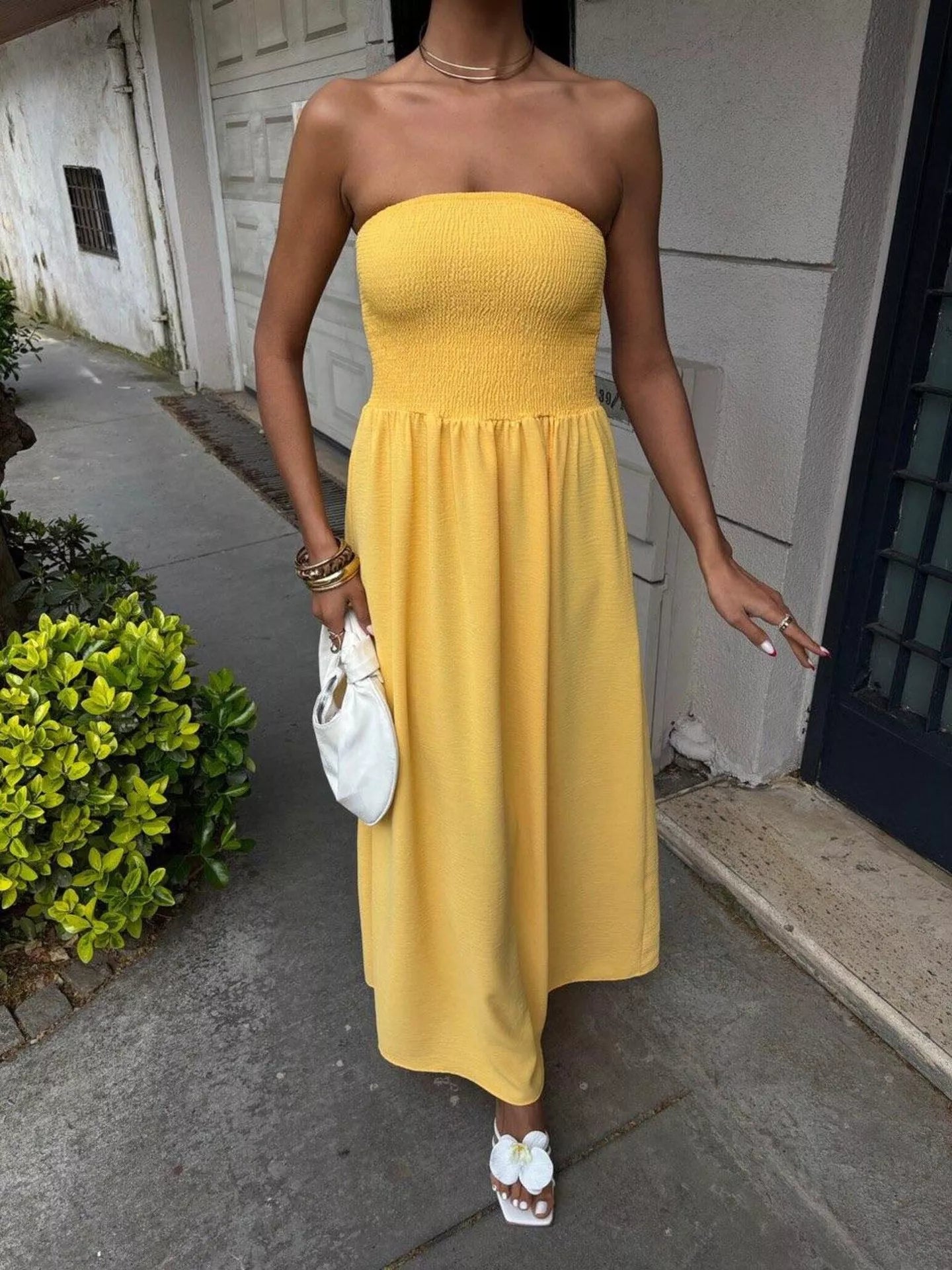 Strapless smocked maxi dress by Plush Fashion Hub featuring a flowing silhouette and floral pattern, perfect for summer wear.