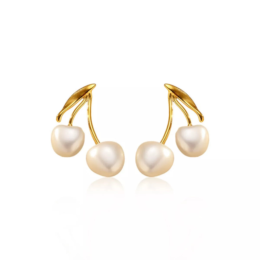Pearl cherry drop earrings by Shopimist featuring white pearls and red cherry-shaped accents on silver hooks.