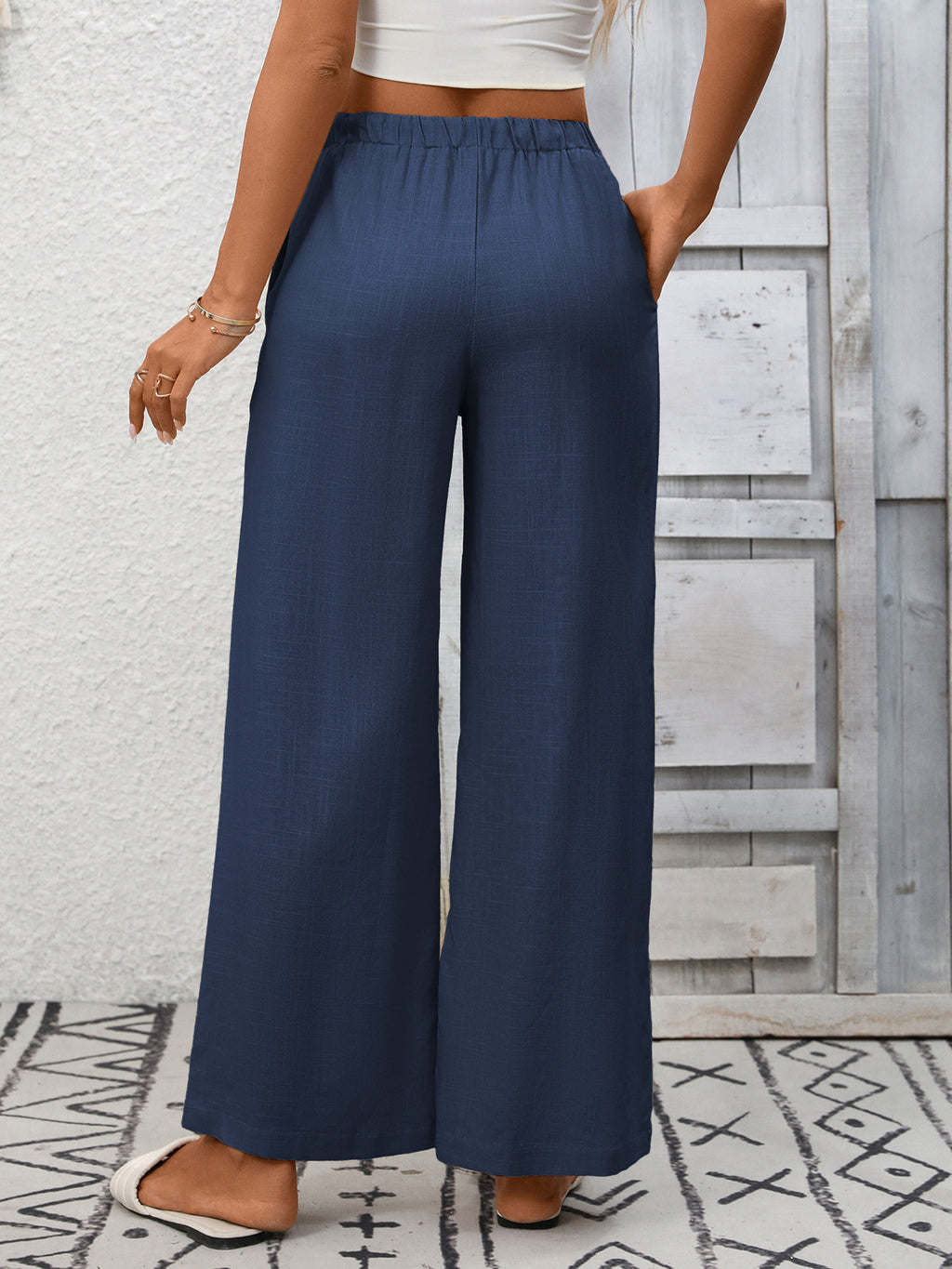 Women's high-waisted wide-leg drawstring pants in soft breathable viscose, shown in a relaxed fit style.