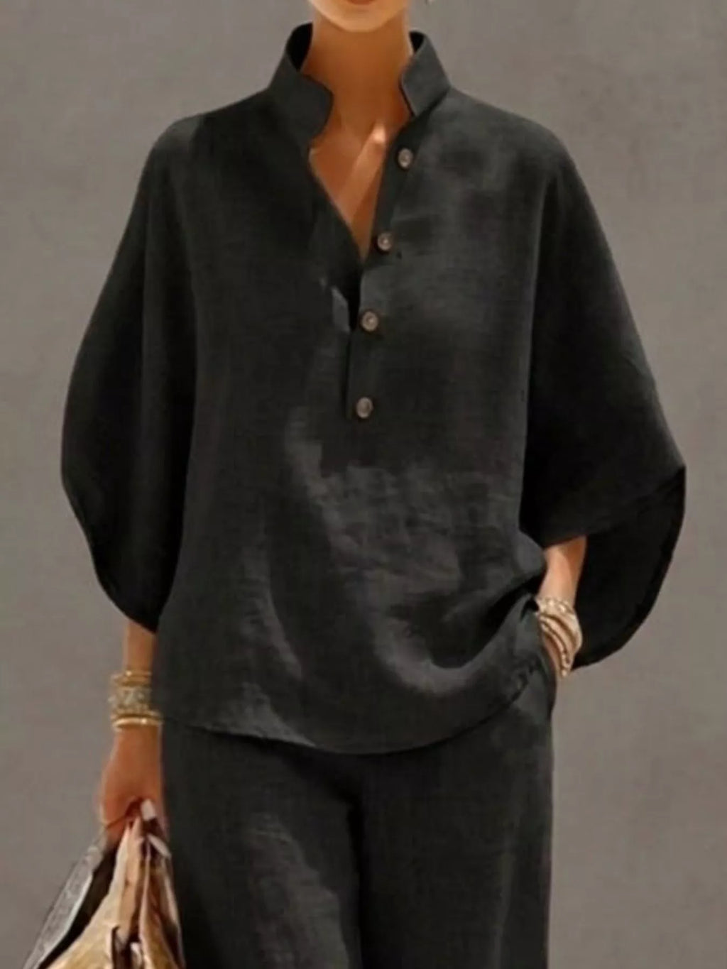 Plus size women's two-piece button-detail 3/4 sleeve top and pants set by Trendsi, shown as a stylish dress ensemble.