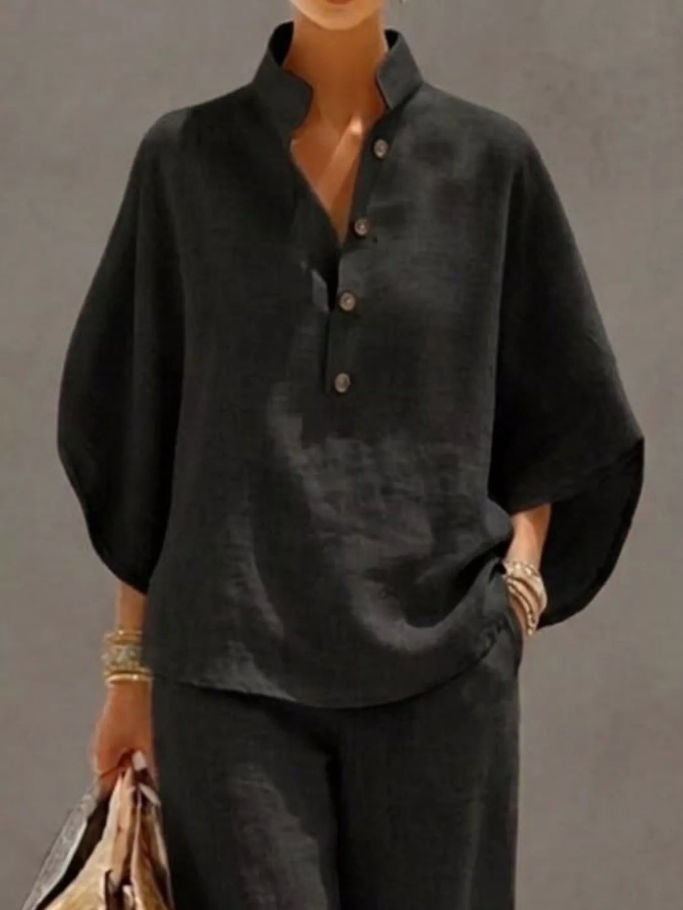 Plus size women's two-piece button-detail 3/4 sleeve top and pants set by Trendsi, shown as a stylish dress ensemble.