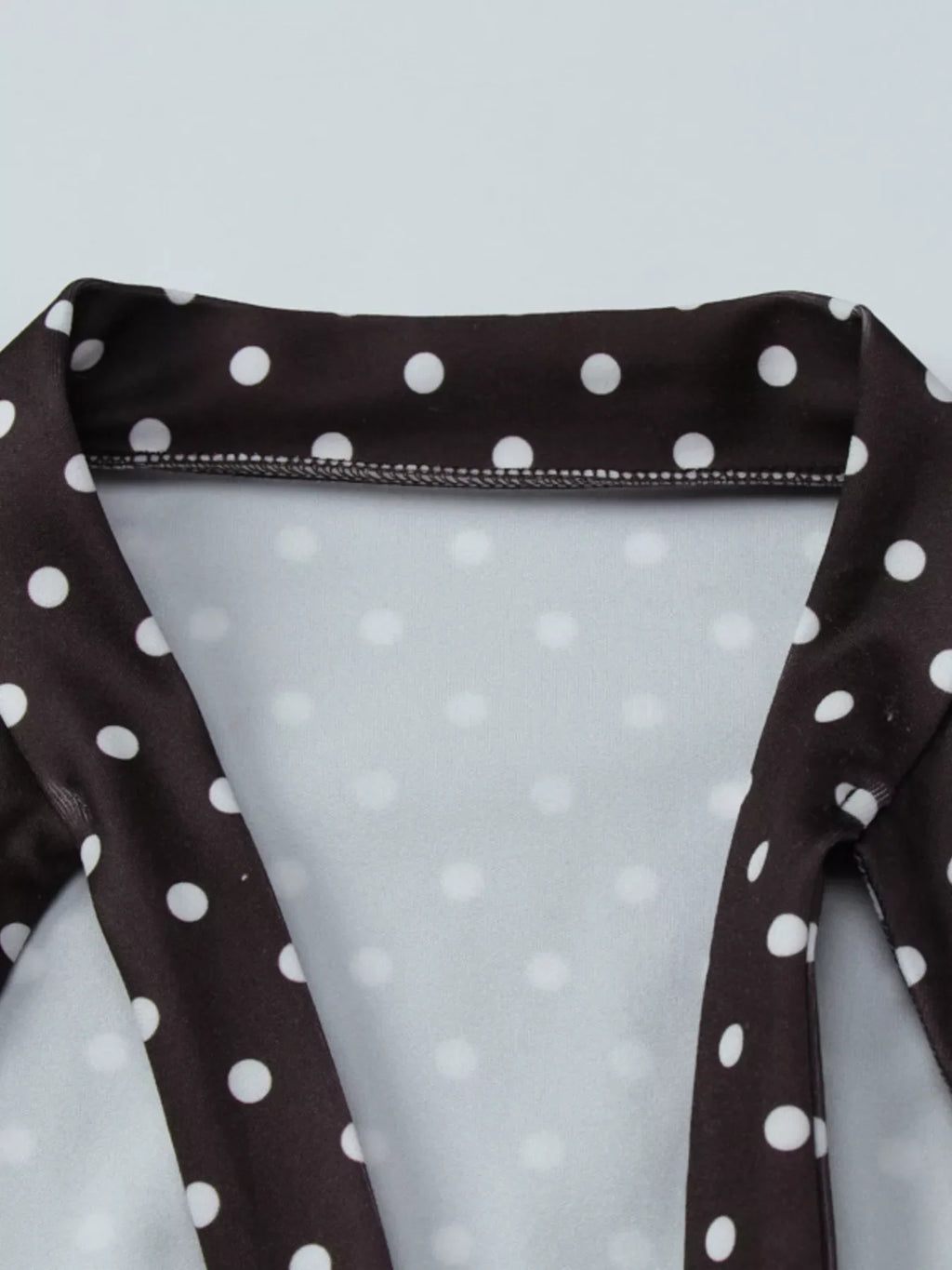 Polka dot mini dress with cut-out front by Shopimist, featuring a stylish design and fitted silhouette.