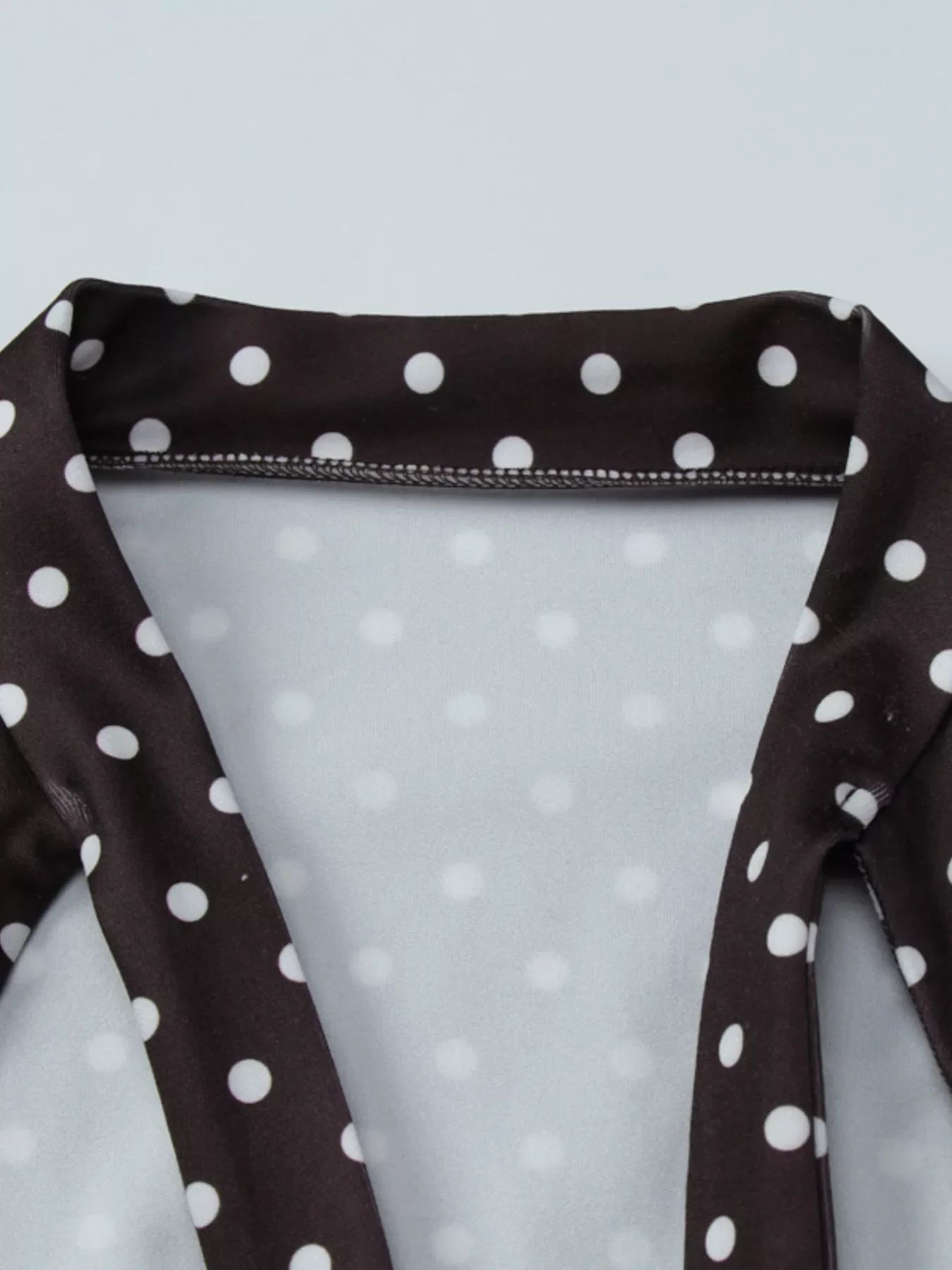 Polka dot mini dress with cut-out front by Shopimist, featuring a stylish design and fitted silhouette.