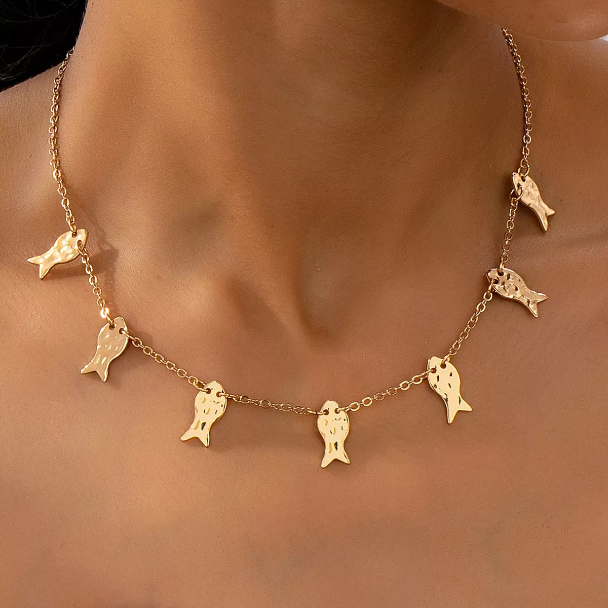 18K gold-plated fish charm necklace featuring a delicate fish pendant on a fine chain, perfect for adding subtle elegance.