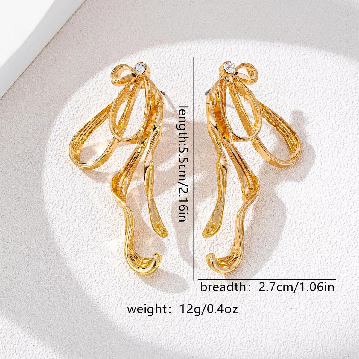18K gold-plated bow earrings with delicate design, featuring shiny finish and elegant style, perfect for accessorizing.