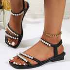 Pearl-embellished open toe low heel sandals by Trendsi, elegant women's footwear with comfortable design and stylish details.
