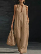 Halter neck wide-leg jumpsuit by Trendsi featuring a stylish design, flowing fabric, and a modern silhouette for a chic look.