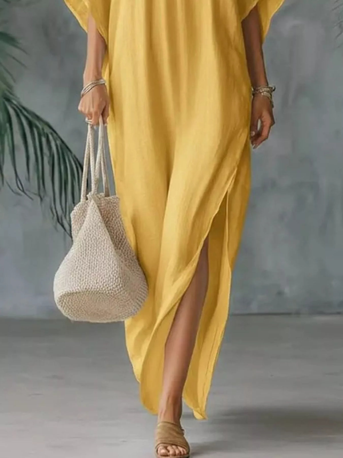 Plush Fashion Hub plus size V-neck maxi dress with side slits, flowing fabric, and full-length design in vibrant color.
