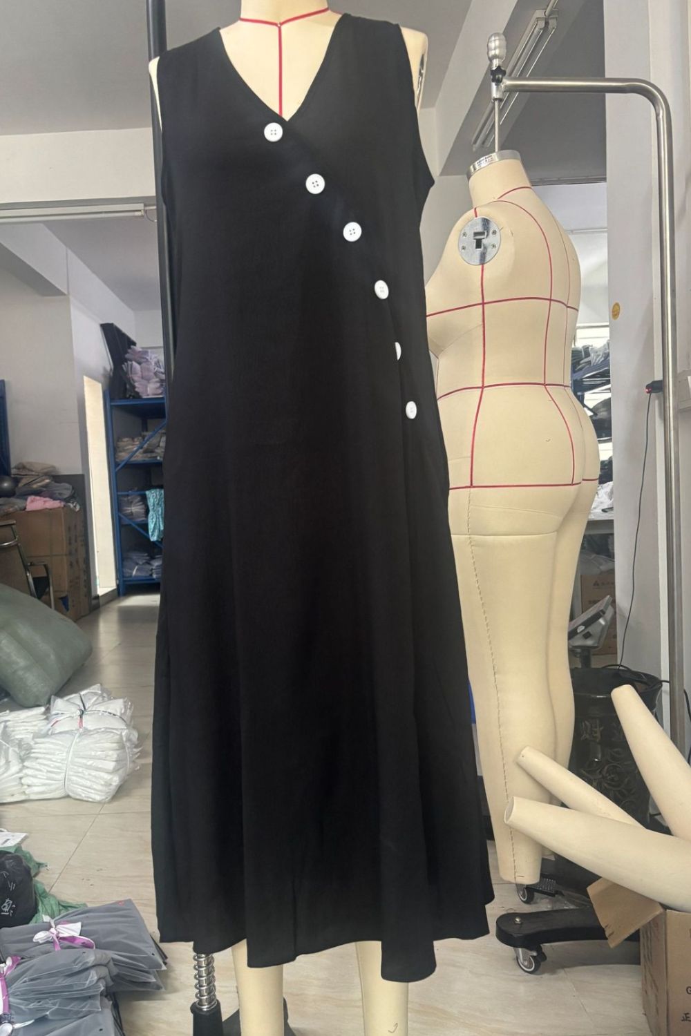 Women's sleeveless button-down midi dress from Trendsi, featuring an elegant A-line casual wear design.