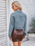 VYSN raw hem denim jacket with front pockets, casual fashion piece, shown with unfolded collar and classic blue denim fabric.