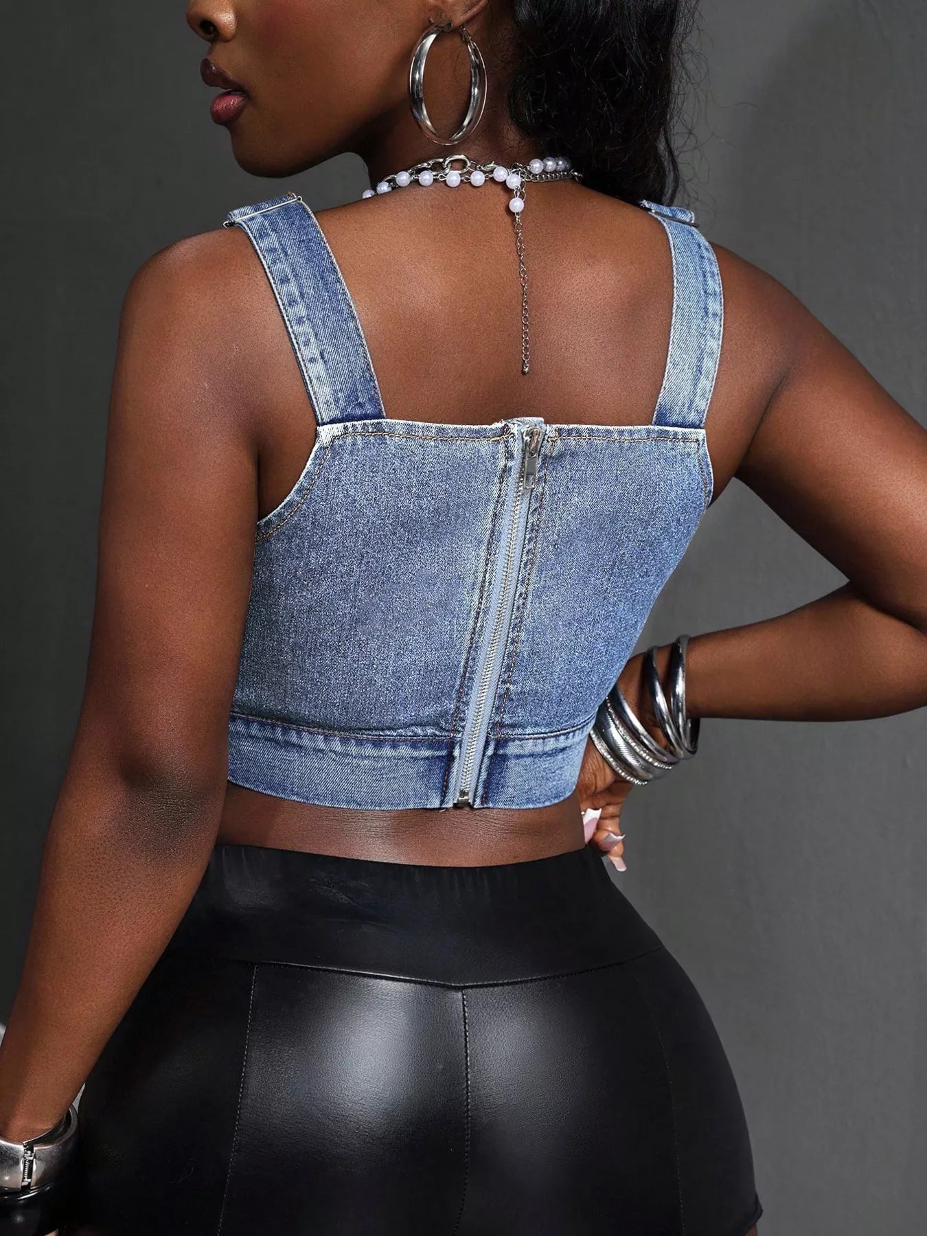 Plush Fashion Hub cropped denim top with adjustable straps, stylish shirt featuring a fitted design and classic blue denim fabric.