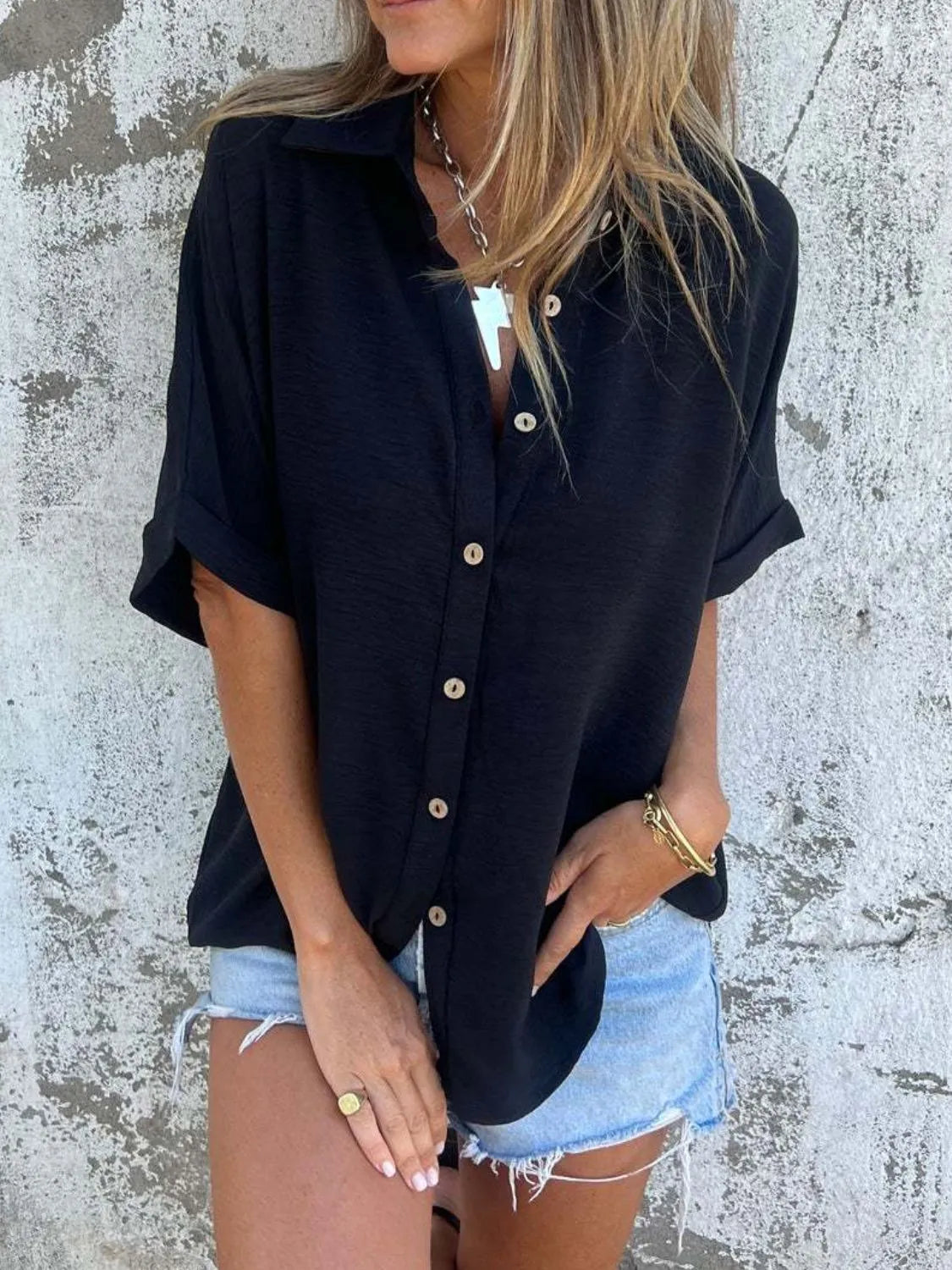 Women's collared half sleeve button-down blouse by Trendsi, showcasing a sophisticated office top with a tailored fit and stylish collar.