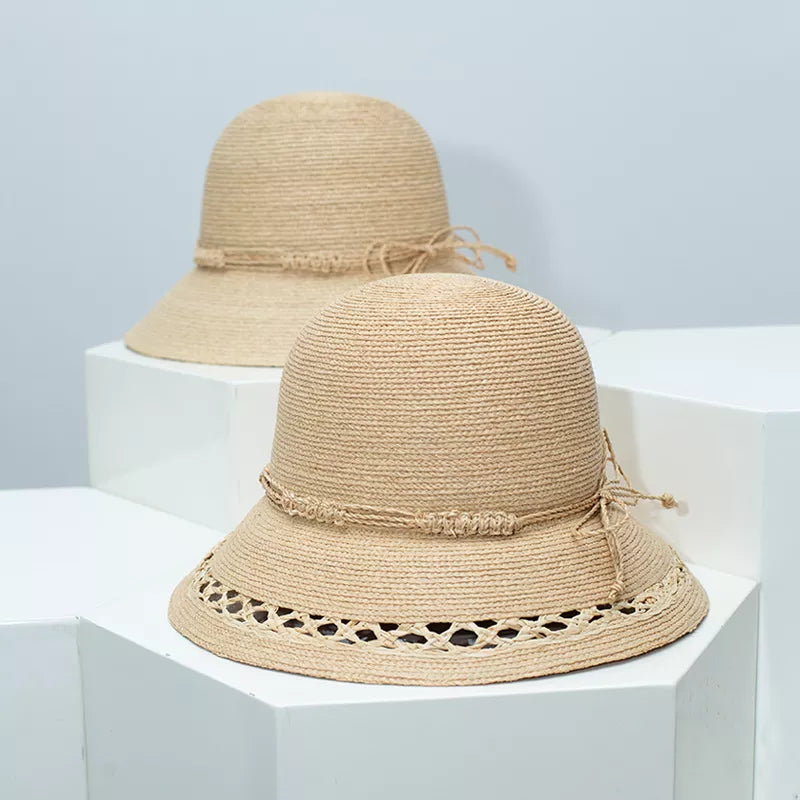 Woven straw bucket hat with decorative band from Plush Fashion Hub, showing its wide brim and stylish design.