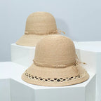 Woven straw bucket hat with decorative band from Plush Fashion Hub, showing its wide brim and stylish design.