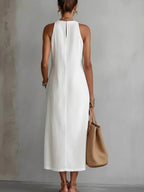 Sleeveless hollow-out midi dress with side slit and pockets from Plush Fashion Hub, shown in a stylish, fitted design.