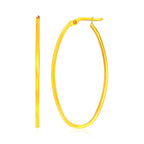 14k yellow gold slim oval shape hoop earrings with a sleek, minimalist design, showcasing elegant gold hoops for women.