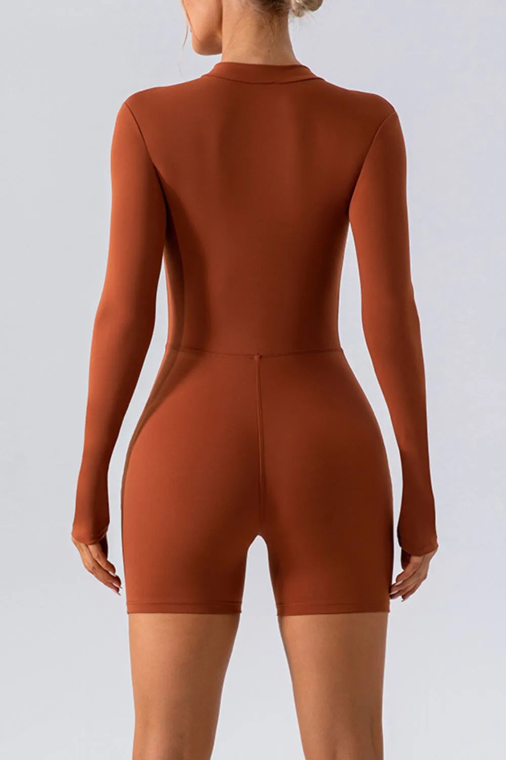 Trendsi half zip long sleeve active romper with stretchy fabric, perfect for workout or casual wear, shown on a mannequin.