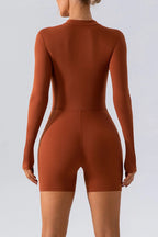 Trendsi half zip long sleeve active romper with stretchy fabric, perfect for workout or casual wear, shown on a mannequin.