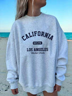 Women's cute kitten graphic sweatshirt from Plush Fashion Hub, featuring a cozy streetwear style with a playful kitten design.
