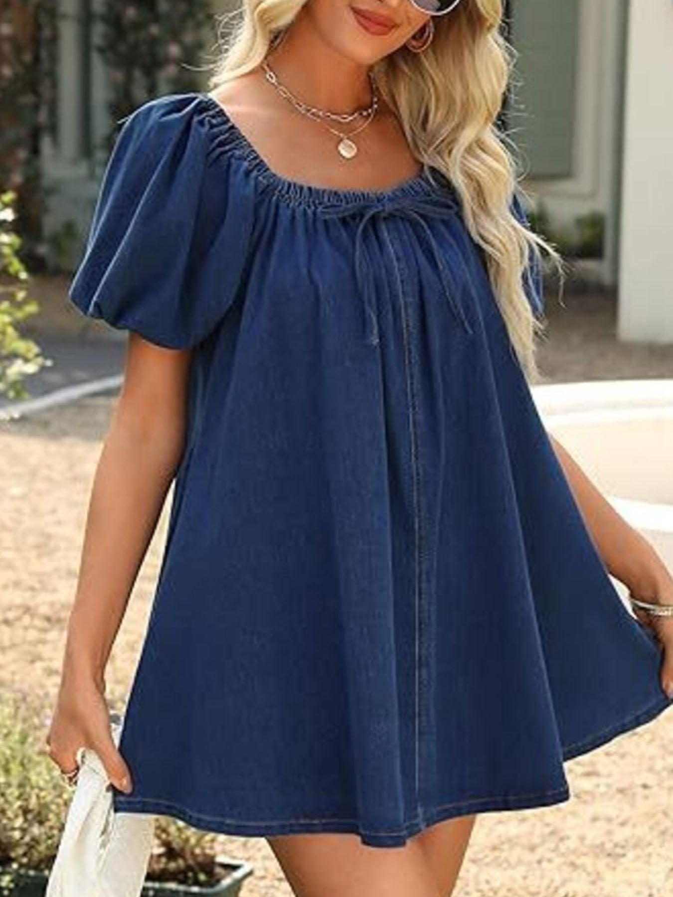 Women's off-shoulder tie-front denim mini dress by Trendsi, casual chic summer style, showcasing a stylish off-shoulder design and denim fabric.