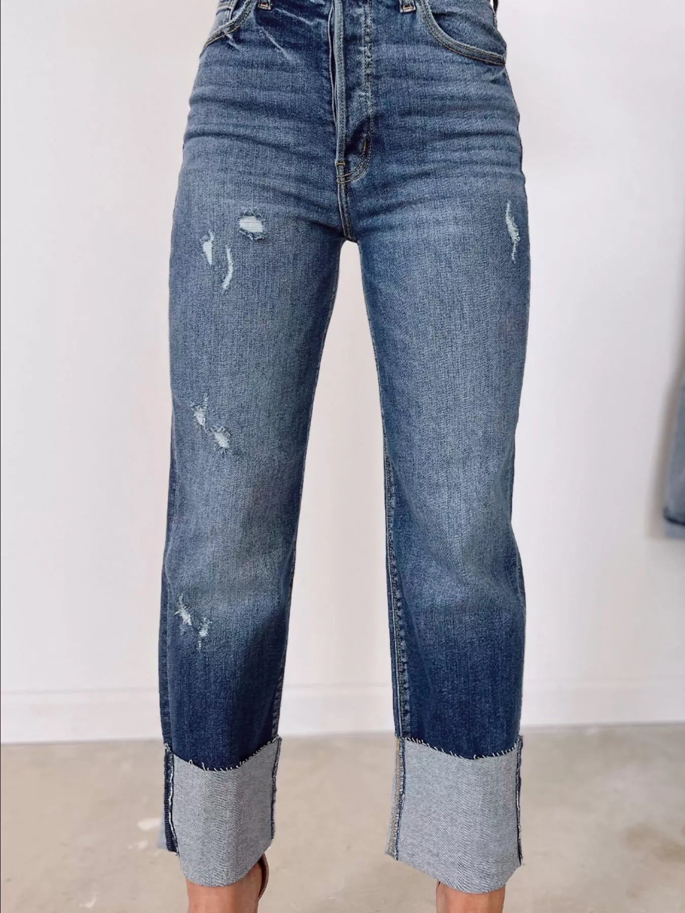 High waist distressed straight leg jeans from Trendsi, showing fitted denim with ripped details and classic five-pocket design.