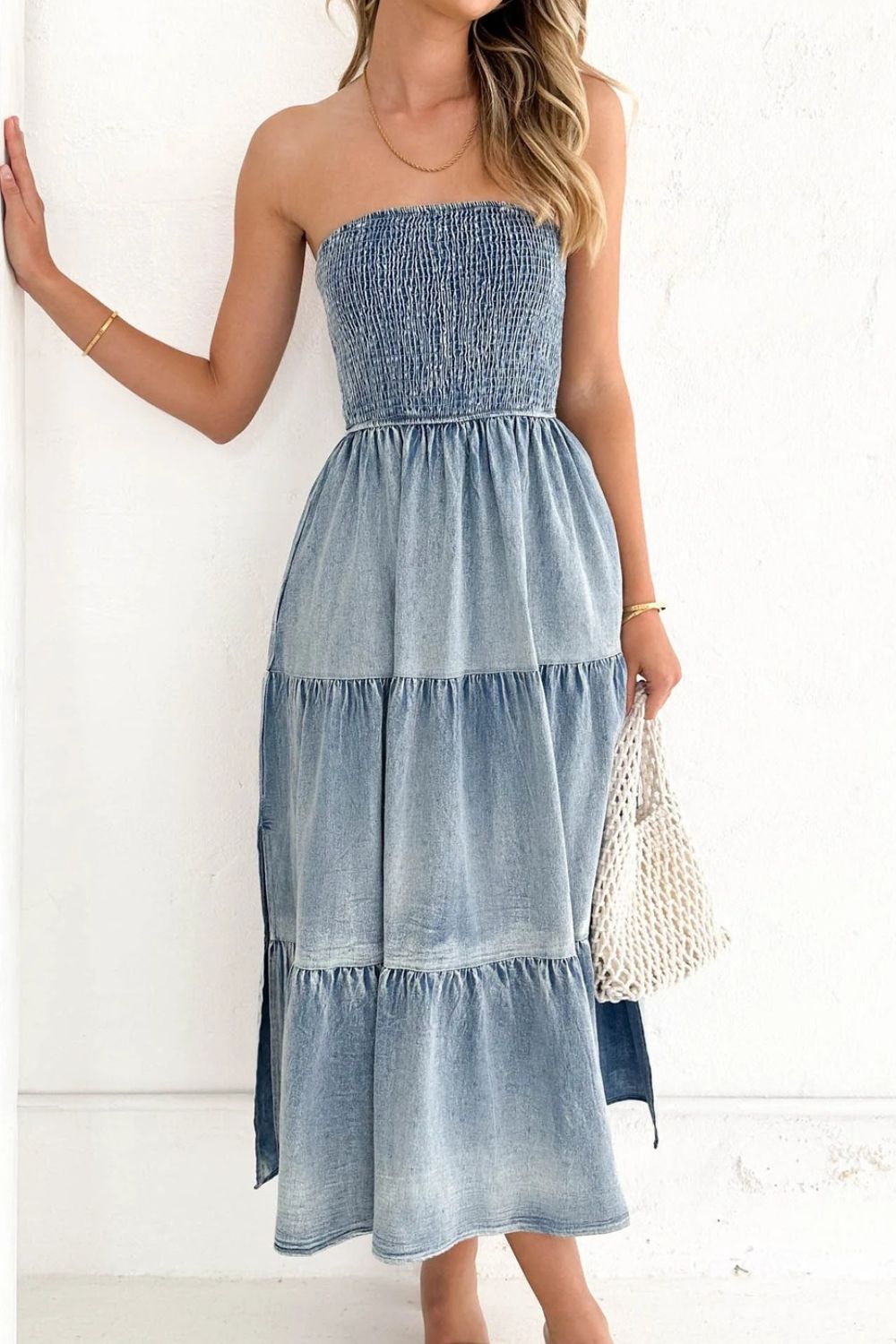 VYSN smocked tube slit tiered denim dress featuring a fitted bodice, tiered skirt, and stylish denim fabric.