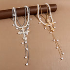 Pearl cross pendant necklace set with three matching pieces, featuring elegant white pearls and silver-tone chains.