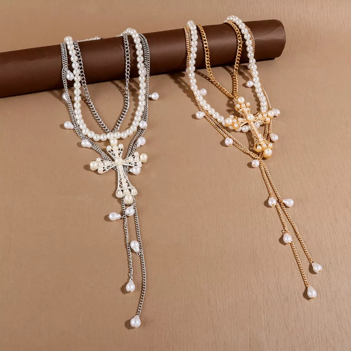 Pearl cross pendant necklace set with three matching pieces, featuring elegant white pearls and silver-tone chains.