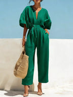 Trendsi tie waist wide-leg bodysuit with plunging neckline and fitted silhouette, made from smooth fabric for a chic look.