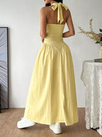 Halter neck ruched maxi dress by Shopimist featuring a flowing silhouette and gathered fabric at the bodice.