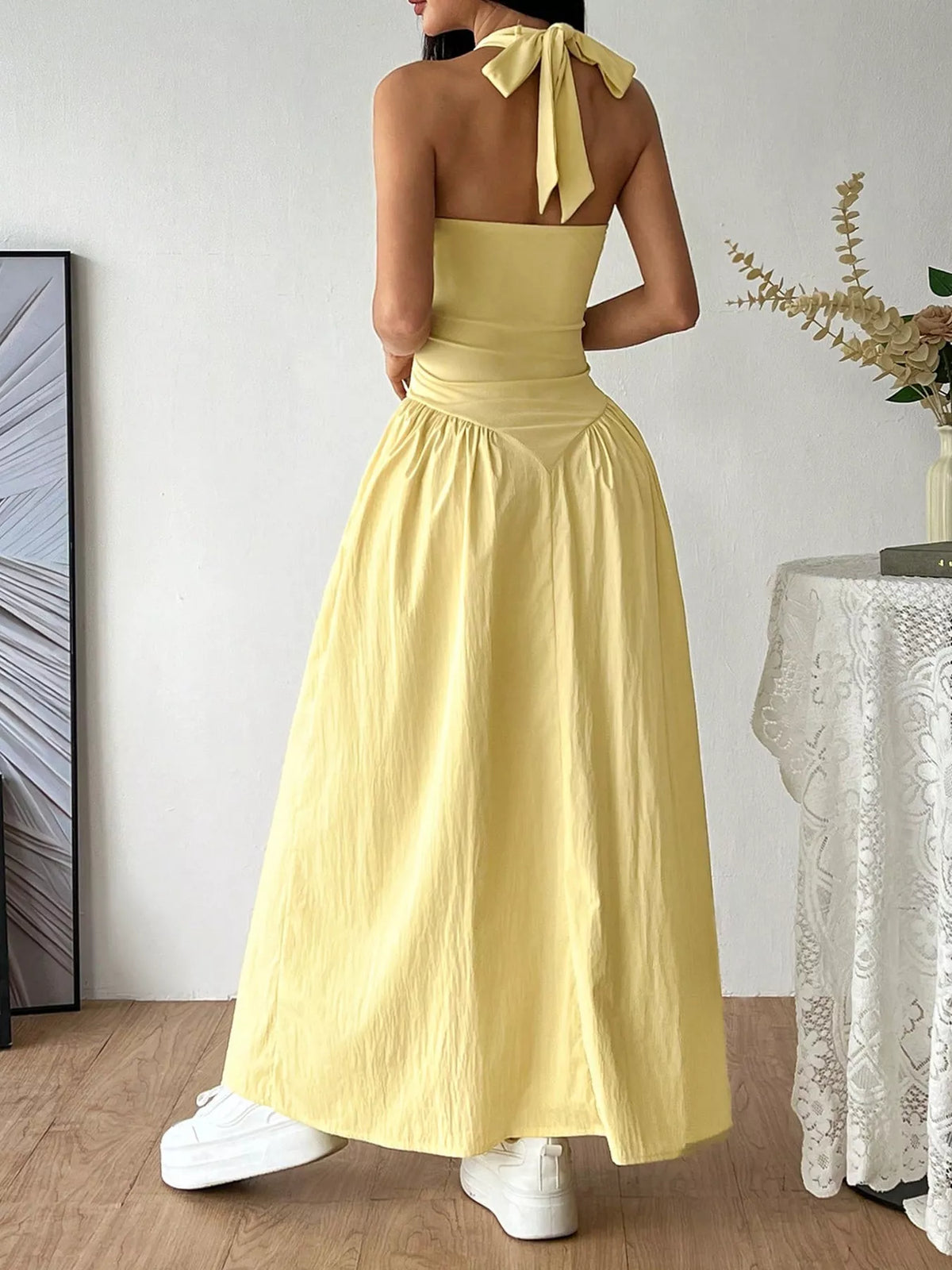 Plush Fashion Hub halter neck ruched maxi dress in flowing fabric, featuring a fitted bodice and elegant ankle-length skirt.