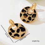 Leopard print circle dangle earrings by Shopimist featuring gold-tone hooks and bold animal print design