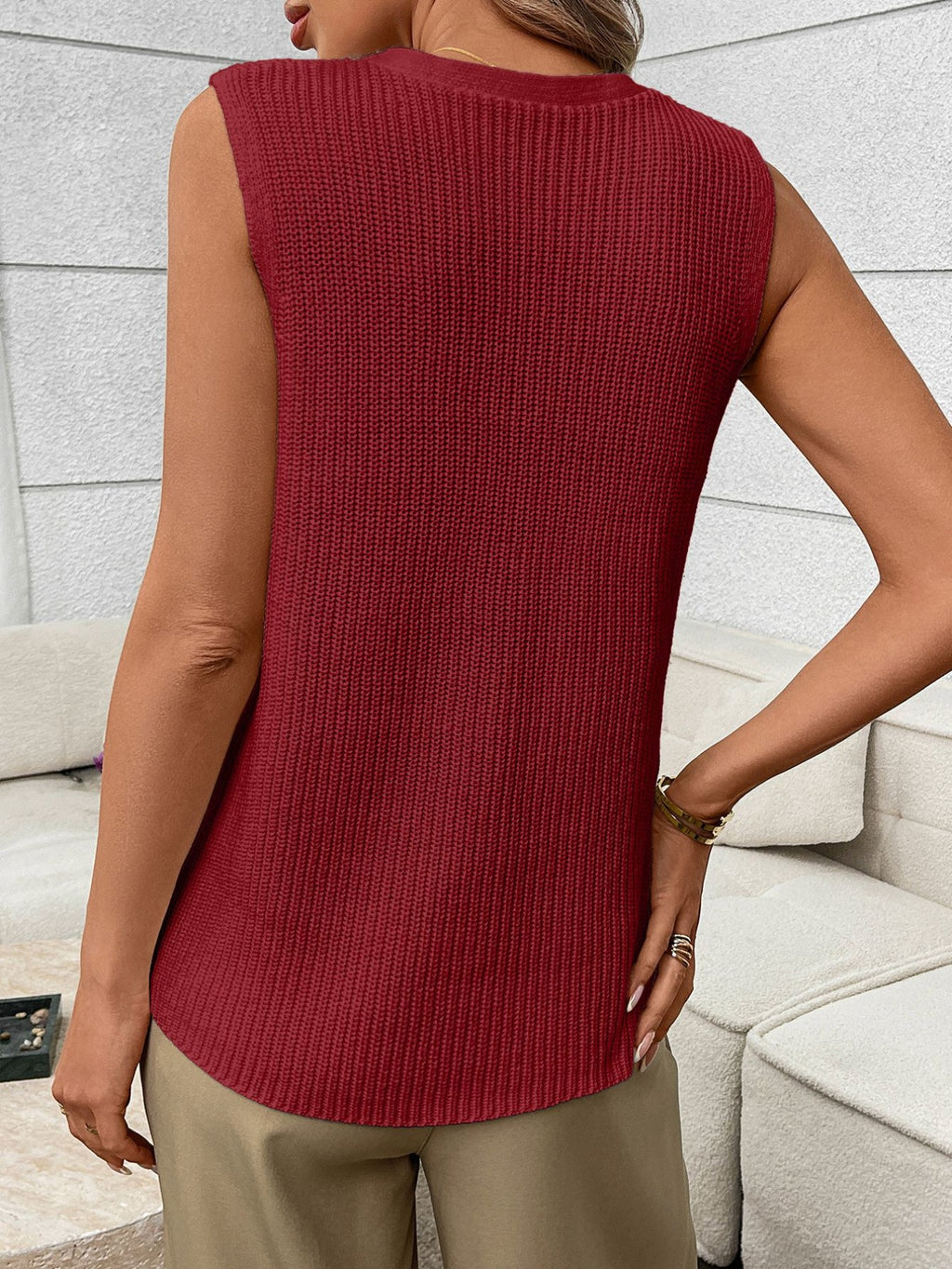 Women's sleeveless knit sweater vest with buttons and side pockets, stylish Trendsi sweater on a model.