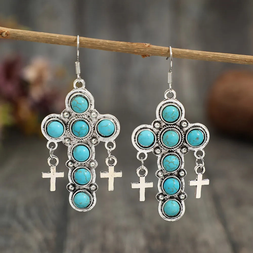 Artificial turquoise cross shape earrings from Plush Fashion Hub featuring vibrant blue cross design in jewelry style.