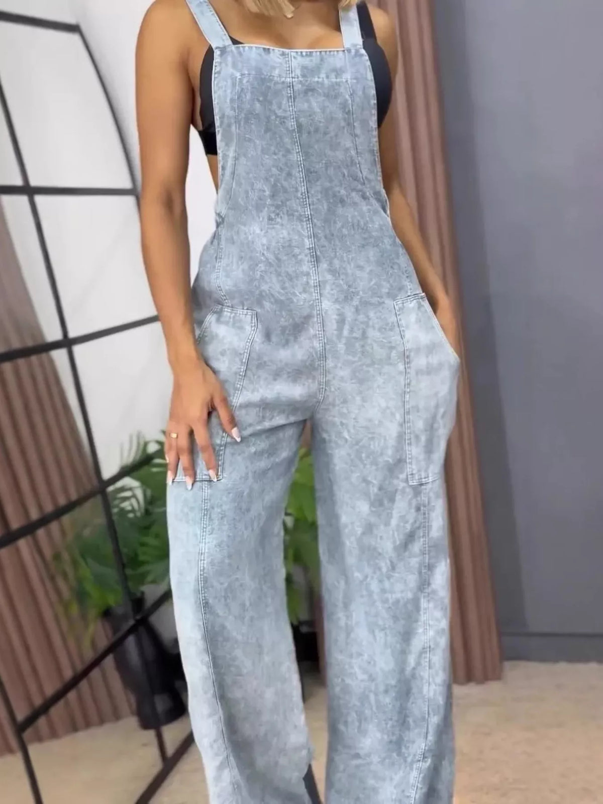 Blue wide-leg denim overalls by Plush Fashion Hub, full-size one-piece jumpsuit with relaxed fit and adjustable straps.