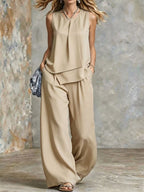 Women's sleeveless two-piece set with solid color wide-leg pants and top from Plush Fashion Hub, displayed on a hanger.
