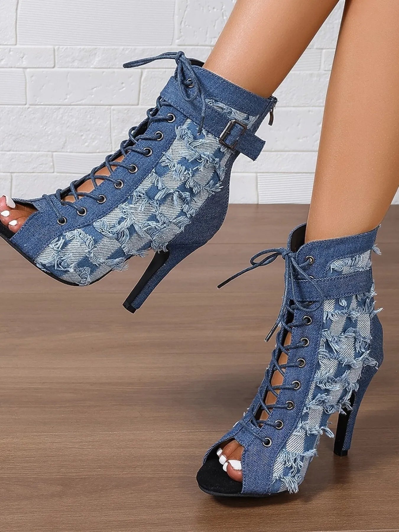 Distressed denim lace-up peep toe high heel ankle boots from Trendsi, featuring a rugged look and stylish design.