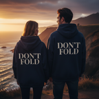 Wear Your Worship Don't Fold Hoodie with bold graphic back print, shown on a model in a casual lifestyle setting.