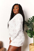 Women's floral long sleeve top and shorts loungewear set from Trendsi, soft fabric, comfortable pajama outfit for relaxed wear.