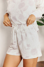 Women’s floral long sleeve top and shorts loungewear set by Trendsi, perfect for comfortable casual wear or relaxing at home.