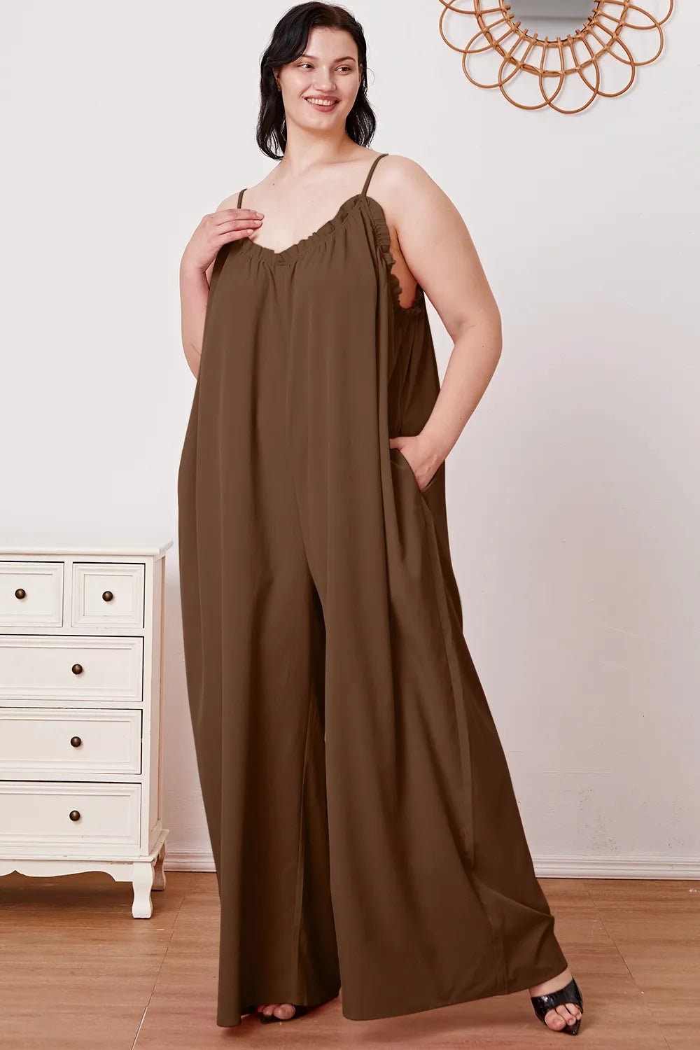 Women’s ruffle trim tie-back cami jumpsuit with pockets, stylish women's apparel by Trendsi, featuring a flattering fit and feminine details.