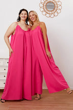 Women's ruffle trim tie-back cami jumpsuit with pockets, stylish summer women's apparel by Trendsi, shown full-length.