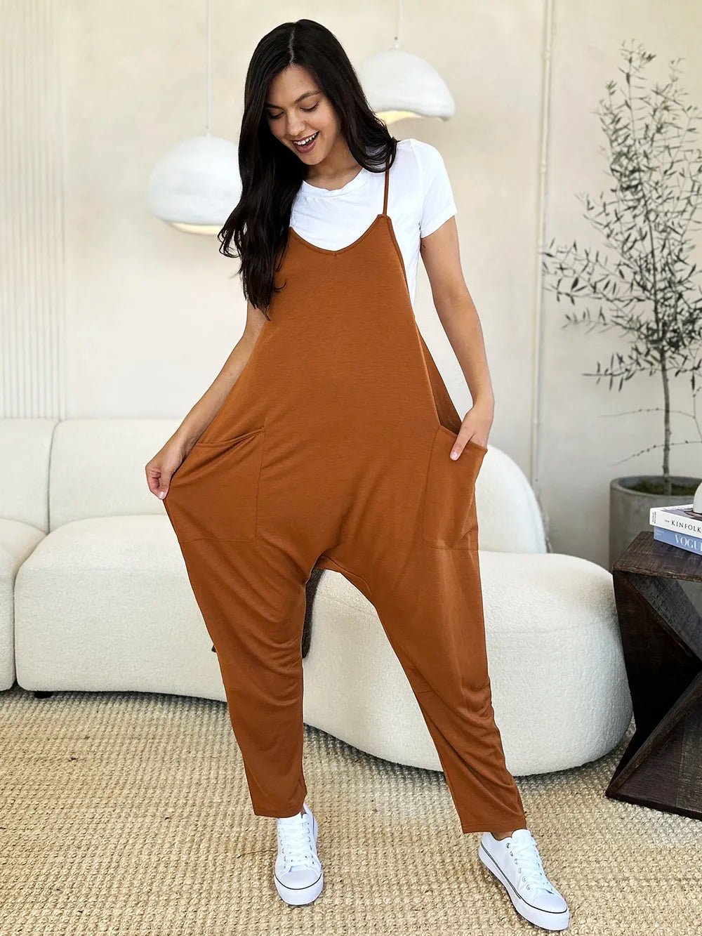Women's sleeveless V-neck wide-leg jumpsuit with pockets, stylish and comfortable, from Trendsi.