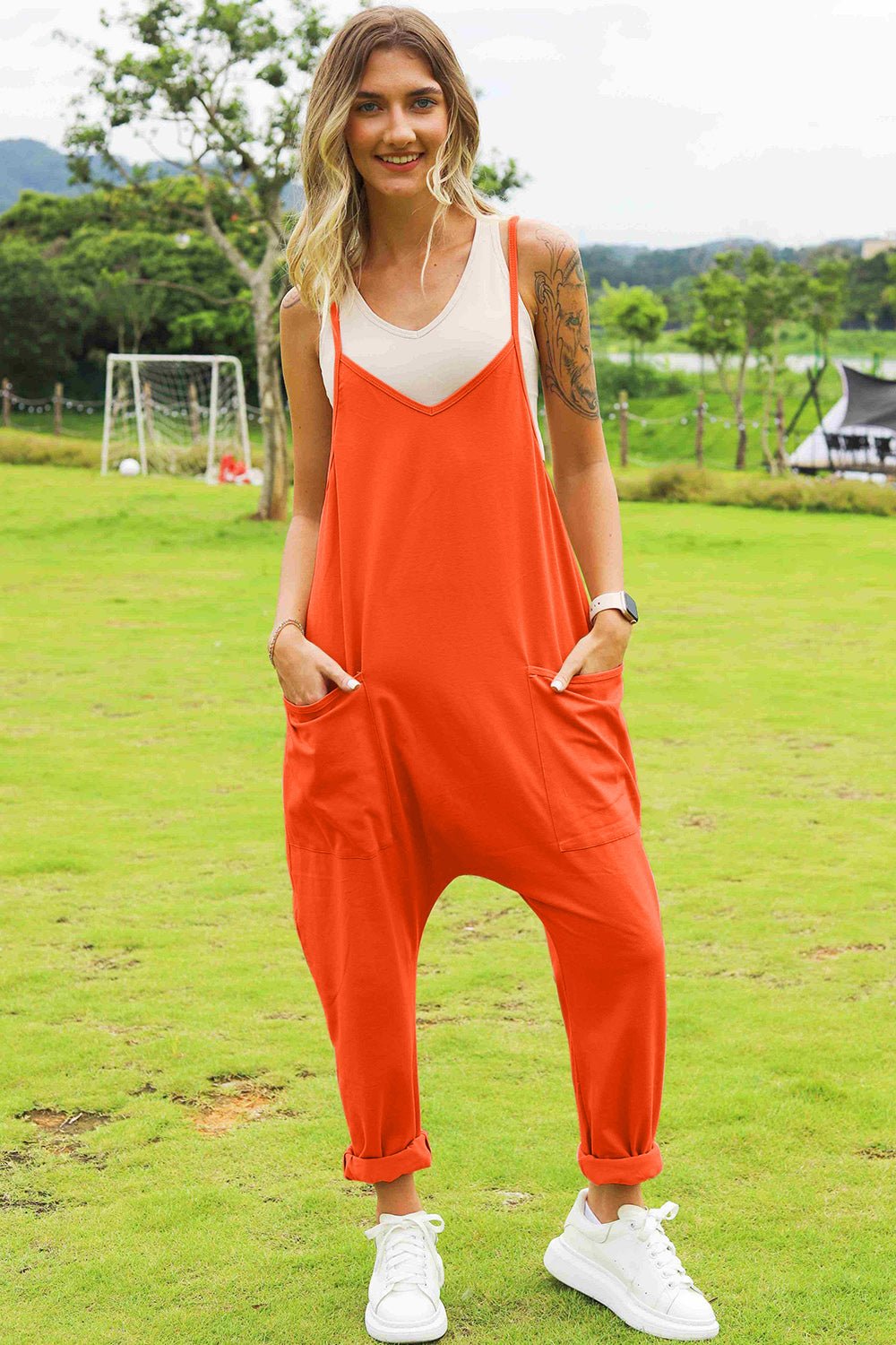 Women's sleeveless V-neck jumpsuit with wide legs and pockets, stylish and comfortable women's apparel by Trendsi.
